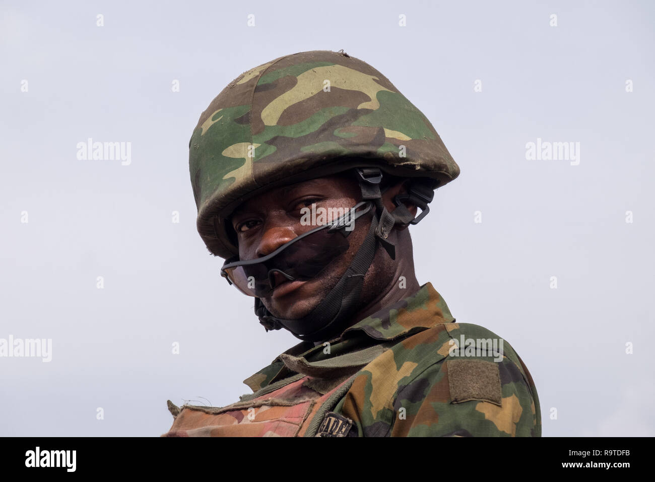 A Nigerian Army soldier looks down from a gun truck near the capital, Abuja. Nigeria has been battling jihadists of Boko Haram since 2011. Stock Photo