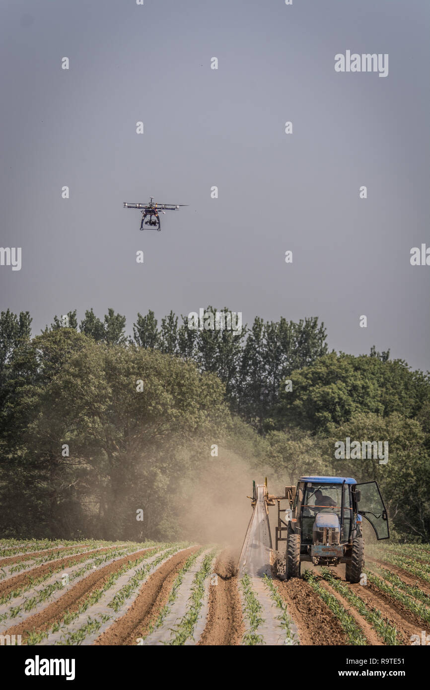 Hexacopter flying oer agricultural land so farmers can review soil and
