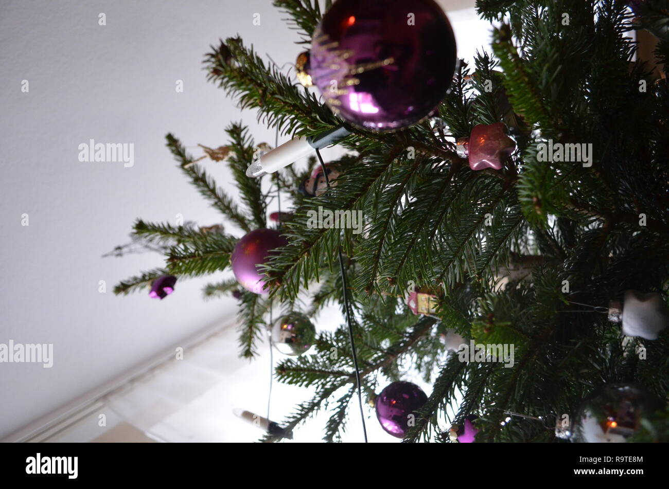 Christmas tree with decoration and ornaments shot from below, amazing perspective Stock Photo