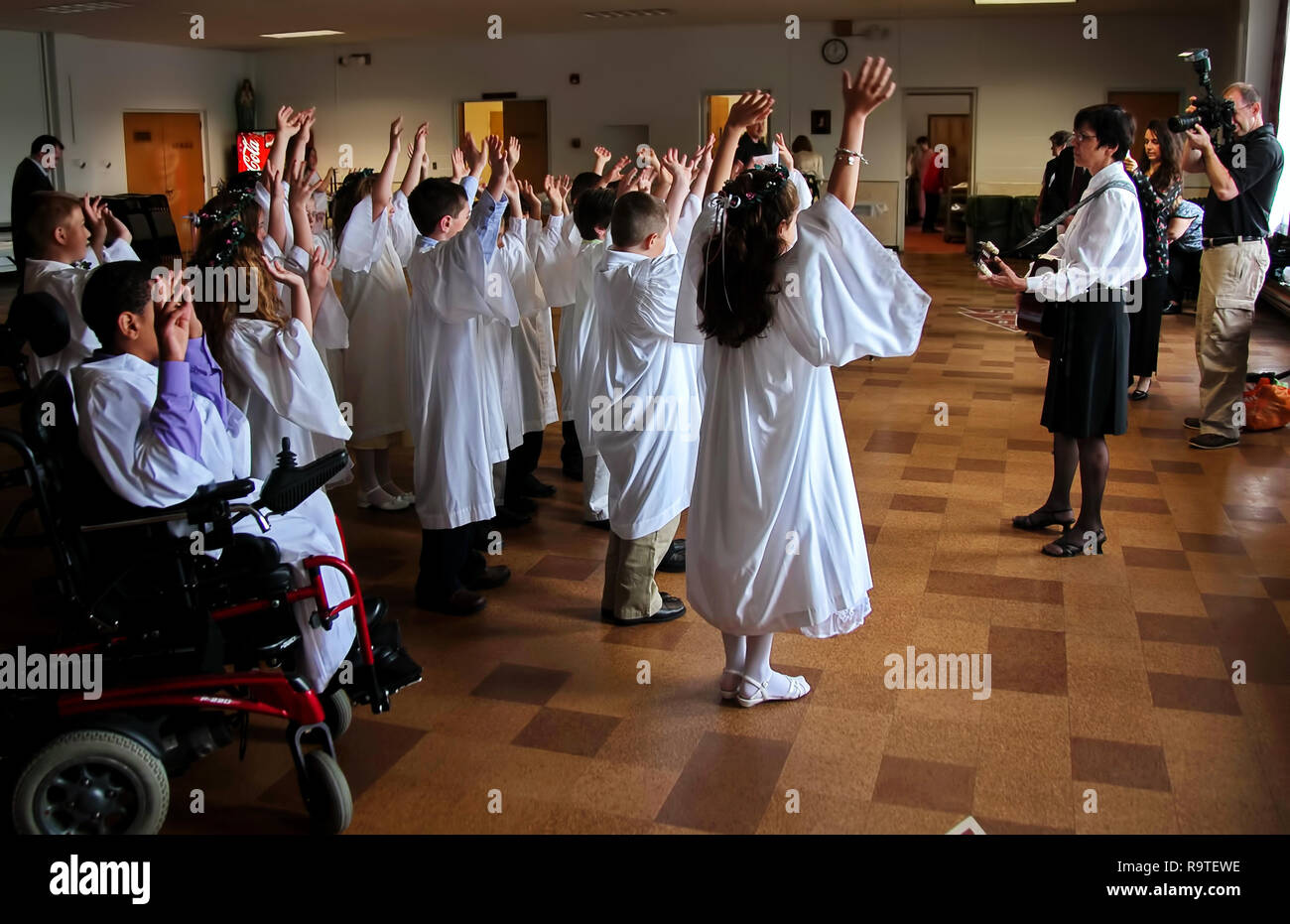 Middletown, CT USA. May 2009. Physically disabled young man in a wheelchair participating in the celebration of First Communion Stock Photo
