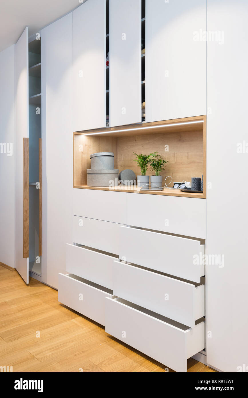 White Wooden Closet With Open Shelves In Bedroom Of Modern