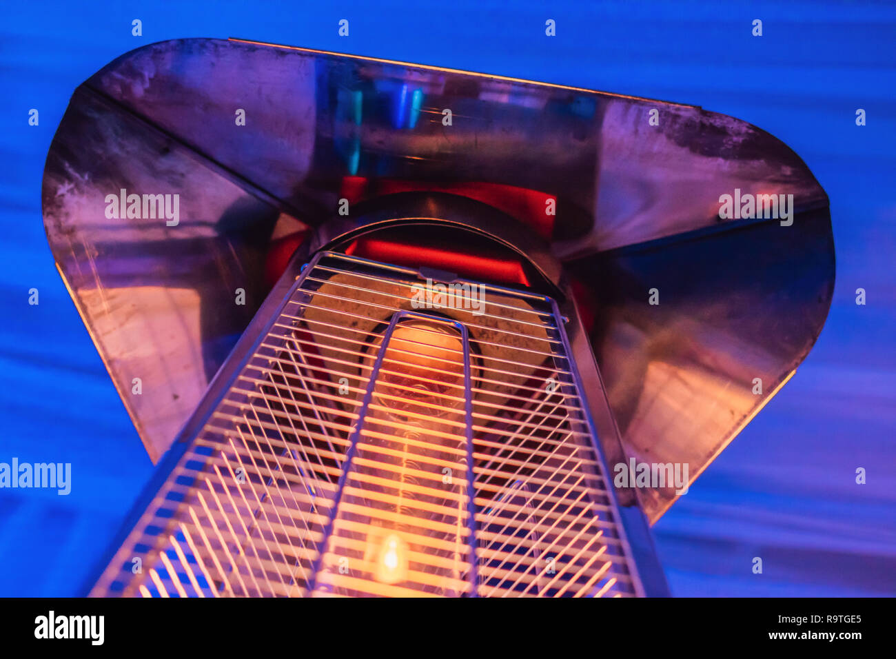 heating lamp heater placed among the tables of an open cafe Stock Photo