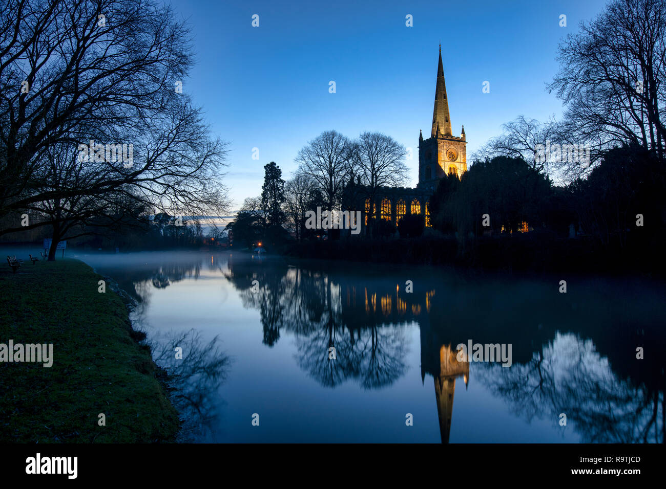 The Holy Trinity Church reflecting in the river avon at dusk on christmas eve. Stratford upon Avon, Warwickshire, England. Silhouette Stock Photo