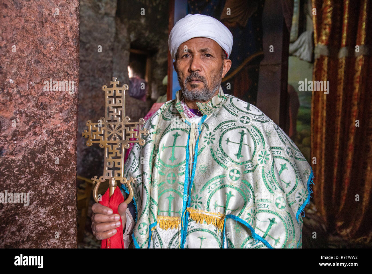Priest at the rock-cut church of House of the Cross at Lalibela, Ethiopia Stock Photo