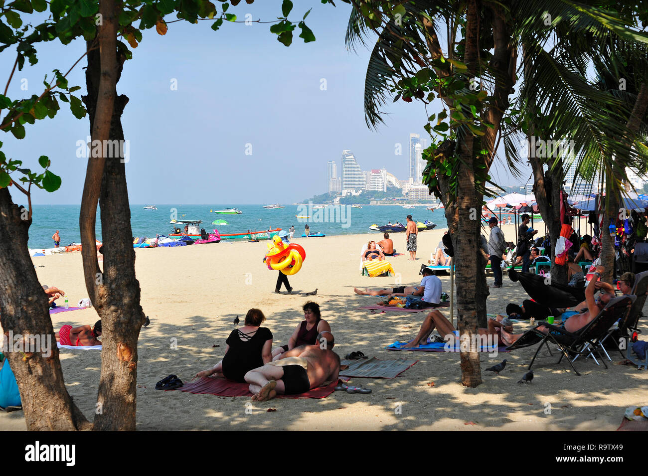 Tourists and Locals on Pattaya Beach Thailand South East Asia Stock Photo