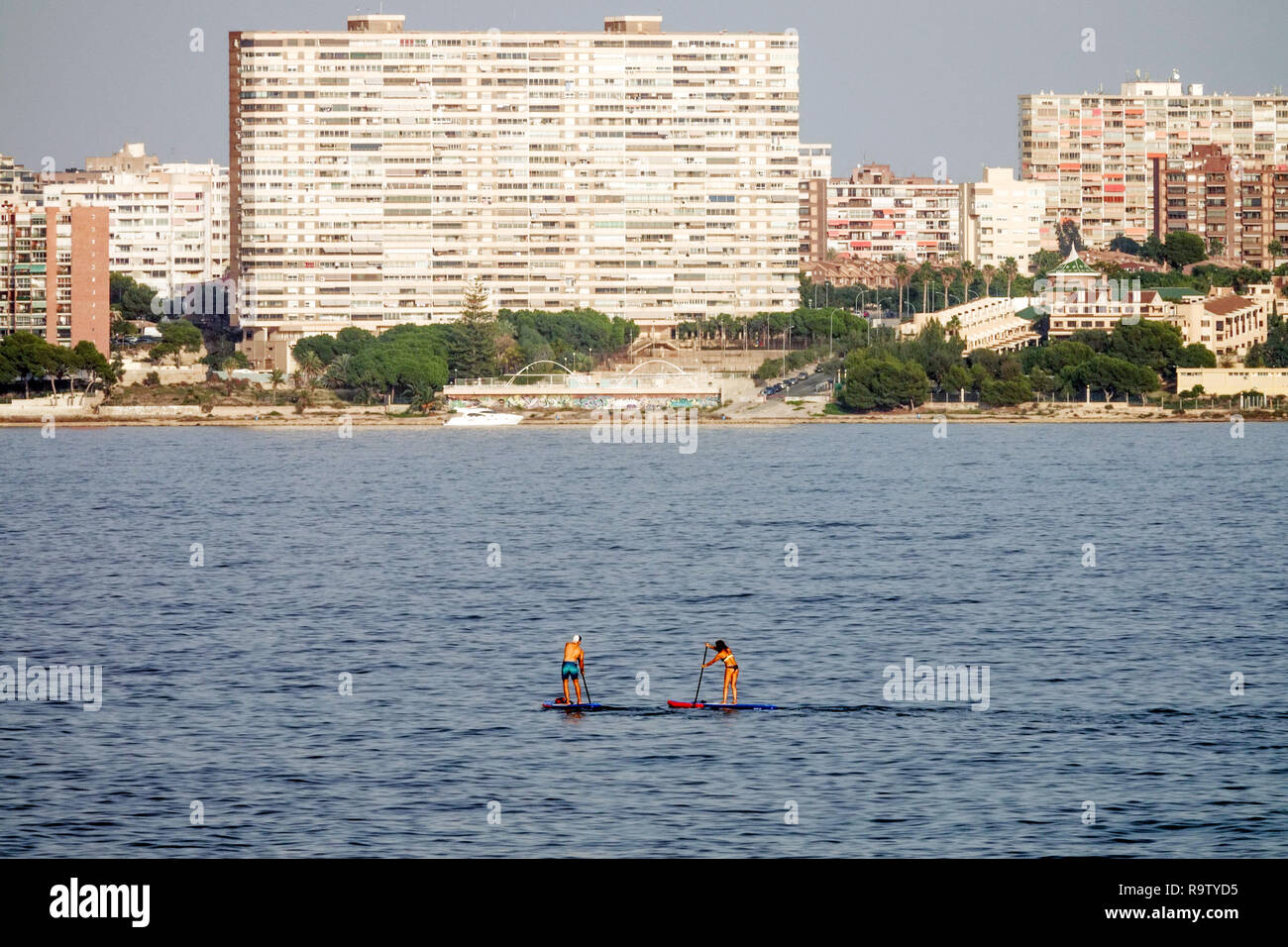 Two paddleboarders on sea, Alicante Spain Paddle boarding sea Stock Photo