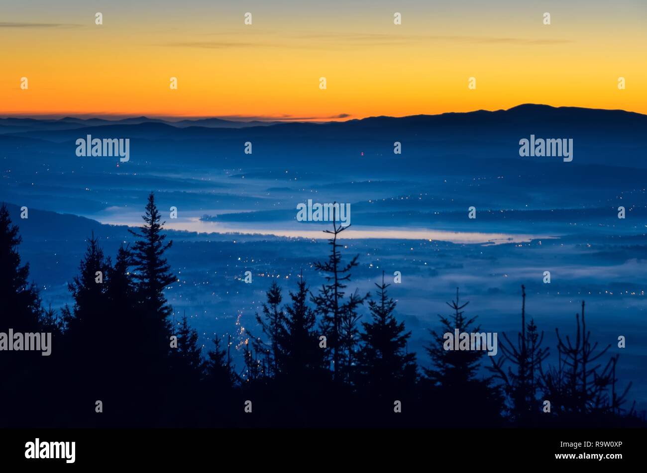 Beautiful morning autumnal mountain landscape. Interesting light over the mountain tops just before dawn. Stock Photo