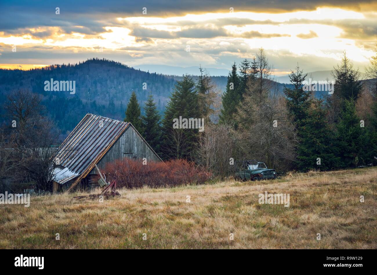 Beautiful mountain autumn landscape. Wooden cabin on a clearing in the mountains. Stock Photo