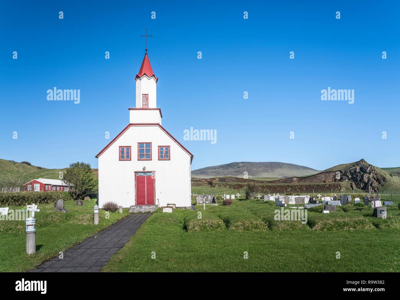 The red roofed The Skeidflatarkirkja Church, Dyrholaey, Myrdalur, Iceland. Stock Photo