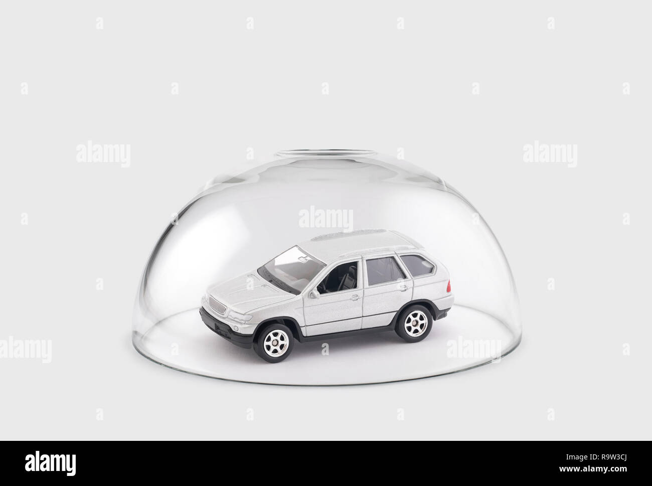 Modern silver car protected under a glass dome Stock Photo