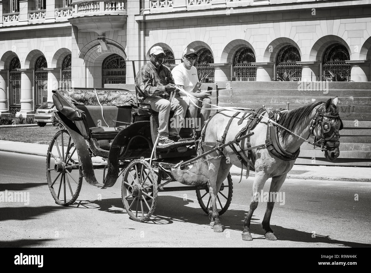 Tourist taking a city tour on a horse carriage in Old Havana, Cuba. Stock Photo