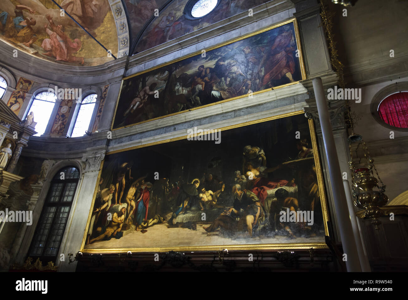 Paintings 'Saint Roch Blessing the Animals' (1567) and 'Saint Roch Healing the Plague-Stricken in the Hospital' (1549) by Venetian Renaissance painter Jacopo Robusti called Tintoretto on display in the Church of Saint Roch (Chiesa di San Rocco) in Venice, Italy. Stock Photo