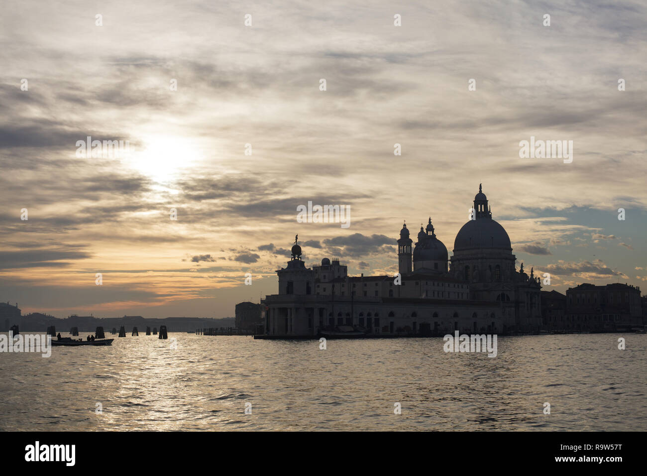 Sunset over the Punta della Dogana and the Basilica of Santa Maria della Salute (Basilica di Santa Maria della Salute) in Venice, Italy. Stock Photo