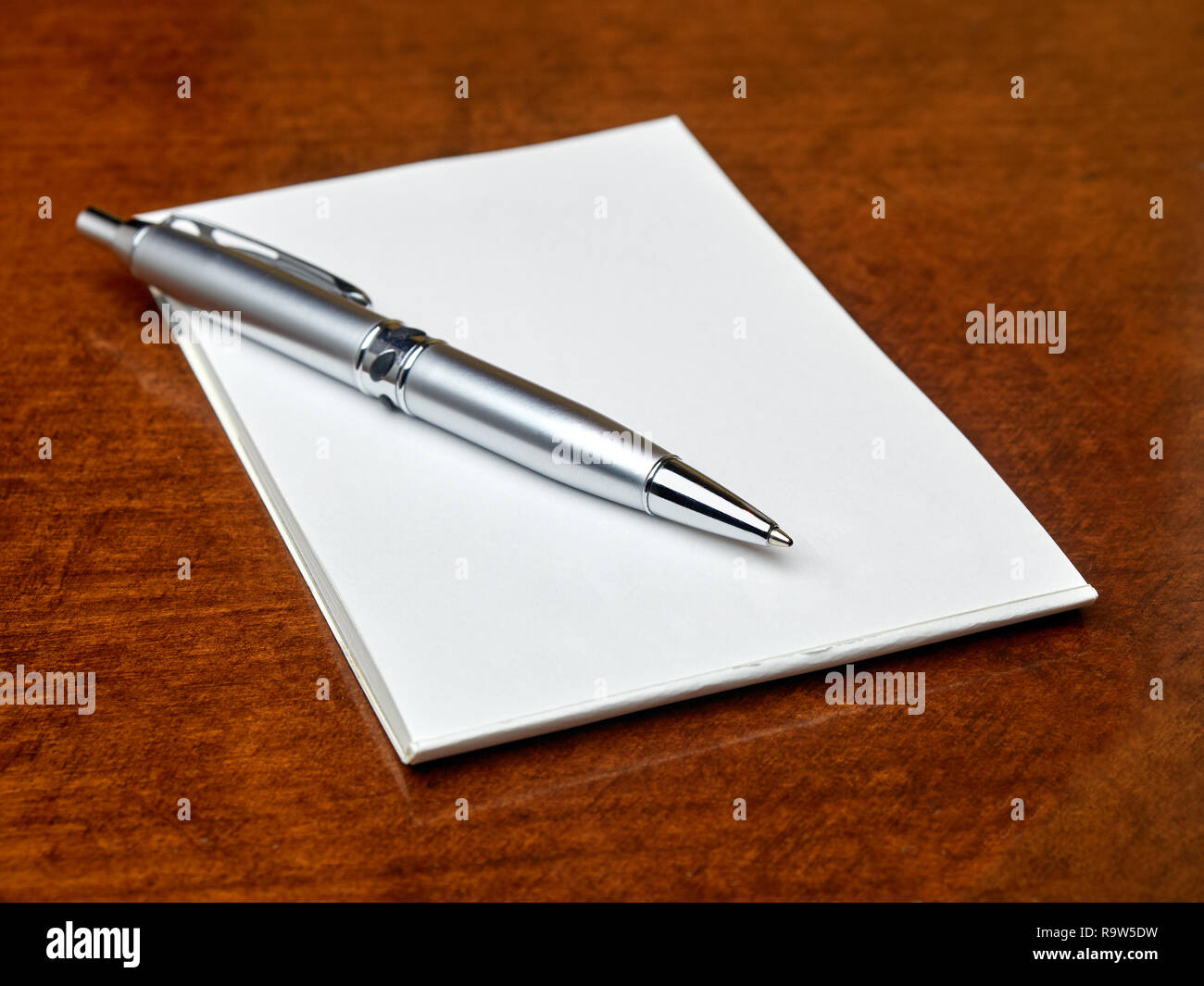 Pen on blank memo book on the table Stock Photo