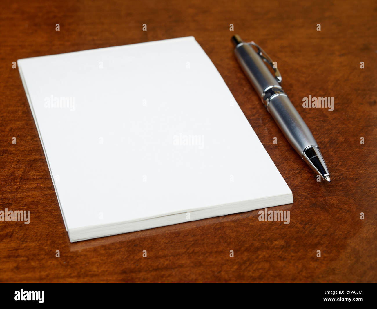 Blank notebook and pen on the table Stock Photo