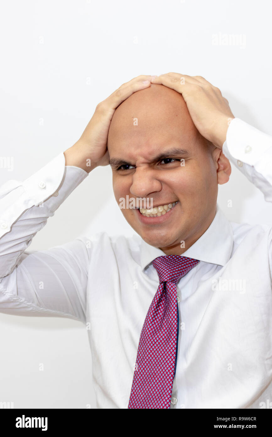 Angry bald man with hands on his head Stock Photo