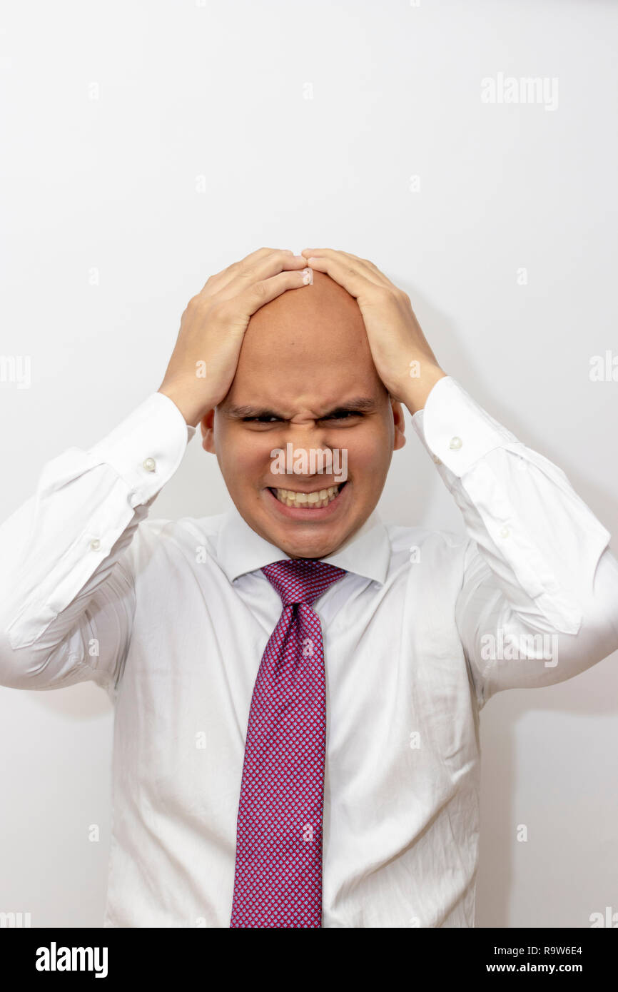 Angry bald man with hands on his head Stock Photo