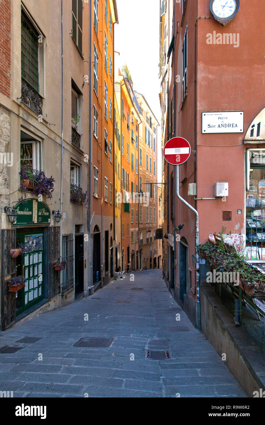 Colorful buildings line narrow Piano di St. Andrea, Old Town Genoa, Italy. Stock Photo