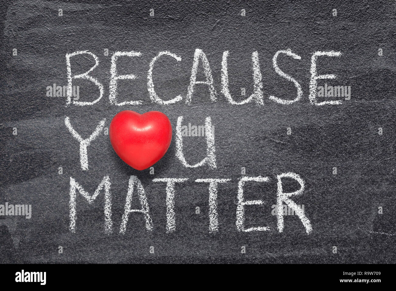 because you matter phrase handwritten on chalkboard with red heart symbol instead of O Stock Photo
