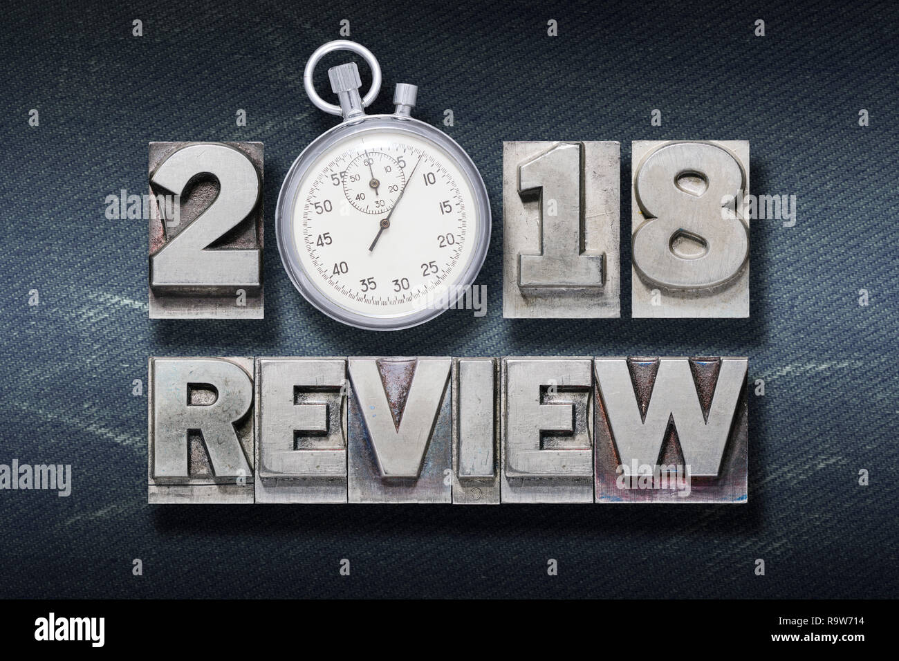 2018 review phrase made from metallic letterpress with stopwatch instead of O Stock Photo