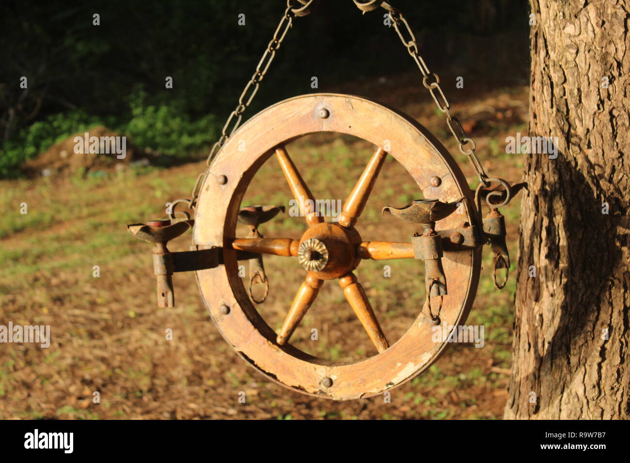 antique lamp hanging on a tree Stock Photo