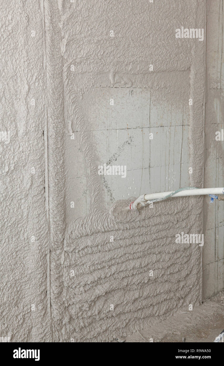 Plastering wall with spray plastering machine for house plastering