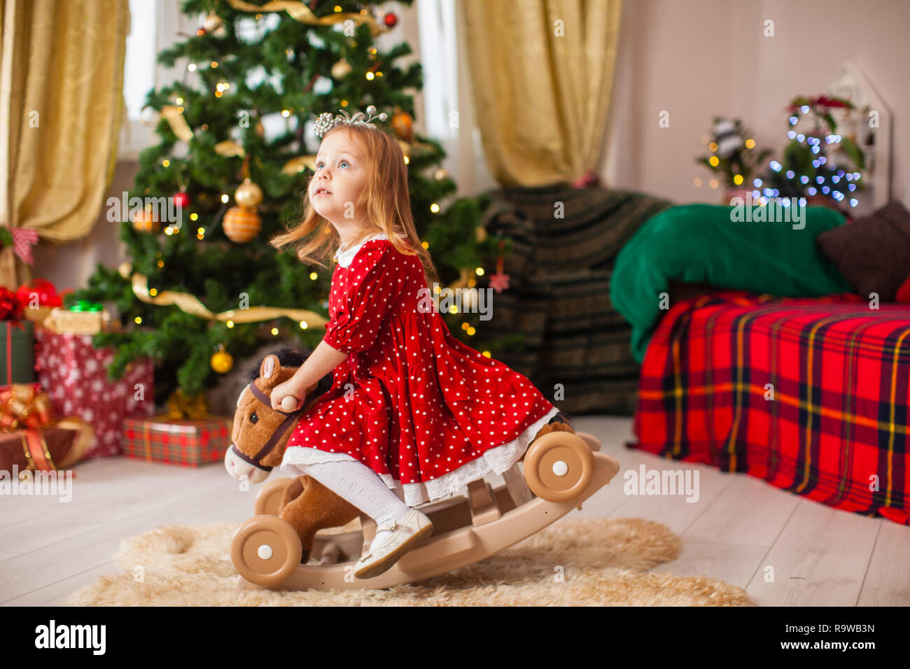 Little girl swings on the rocking hors Stock Photo - Alamy