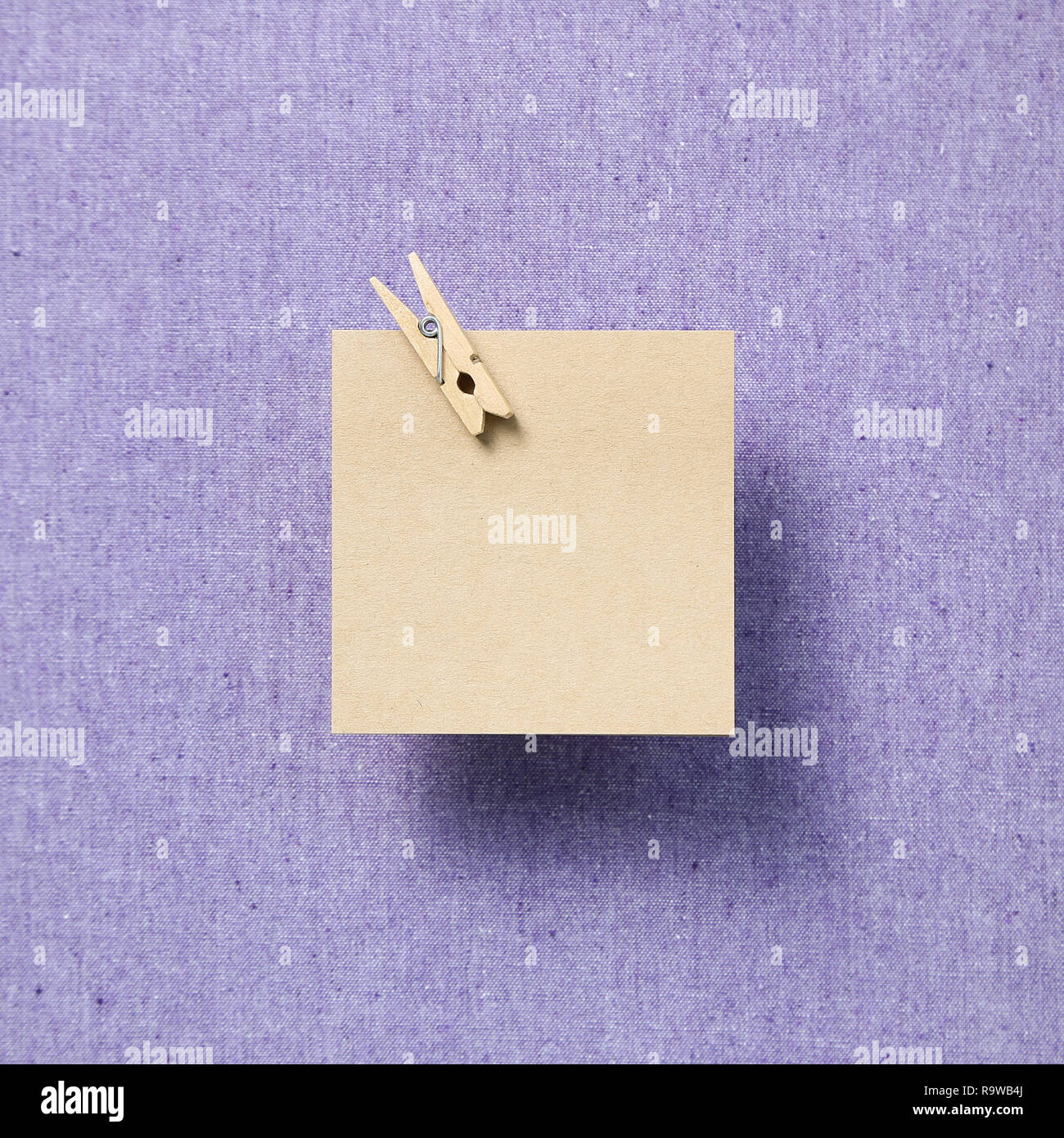 Empty memo paper, sticky notes on purple fabric background Stock Photo