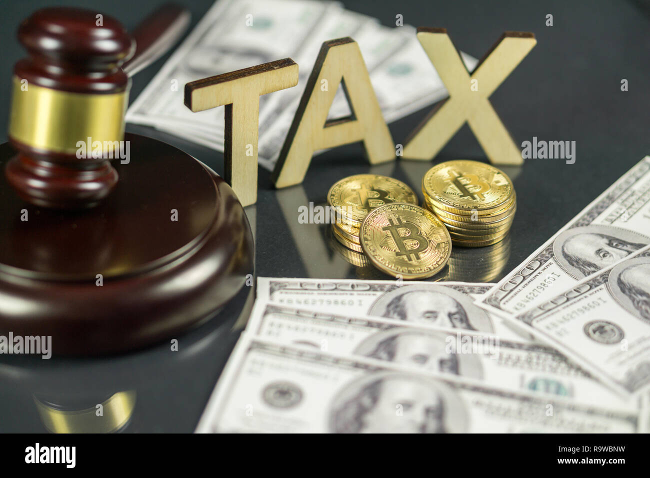 Gavel and cryptocurrency with hundred dollar bills around it. Government  regulation concept. Tax payment Stock Photo - Alamy