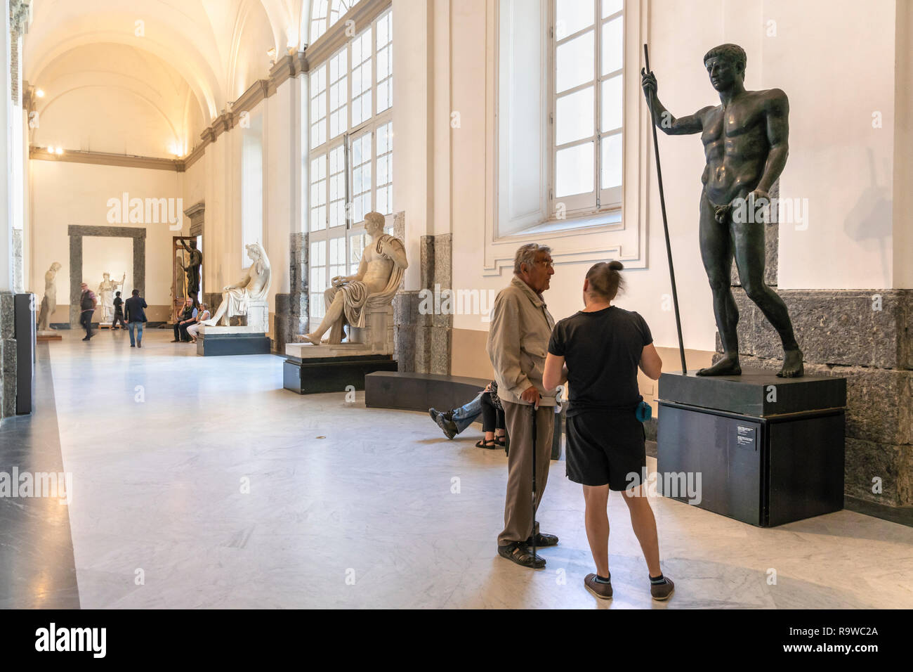 Visitors looking at Roman period sculptures In the National Archaeological Museum at Naples, Italy. Stock Photo