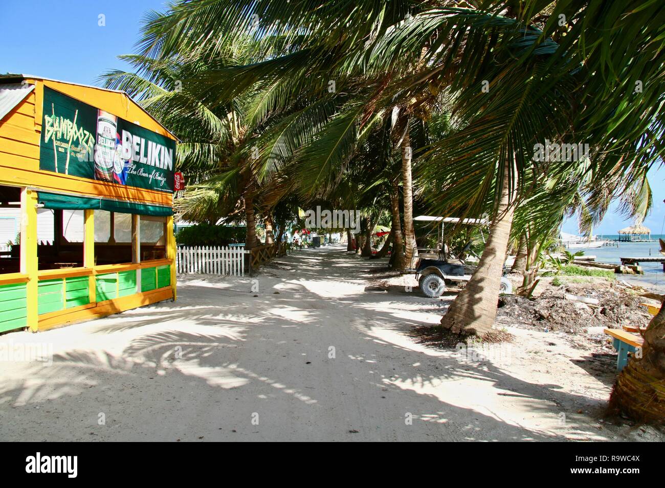 White sand walkway along the shore on Caye Caulker in Belize Stock Photo