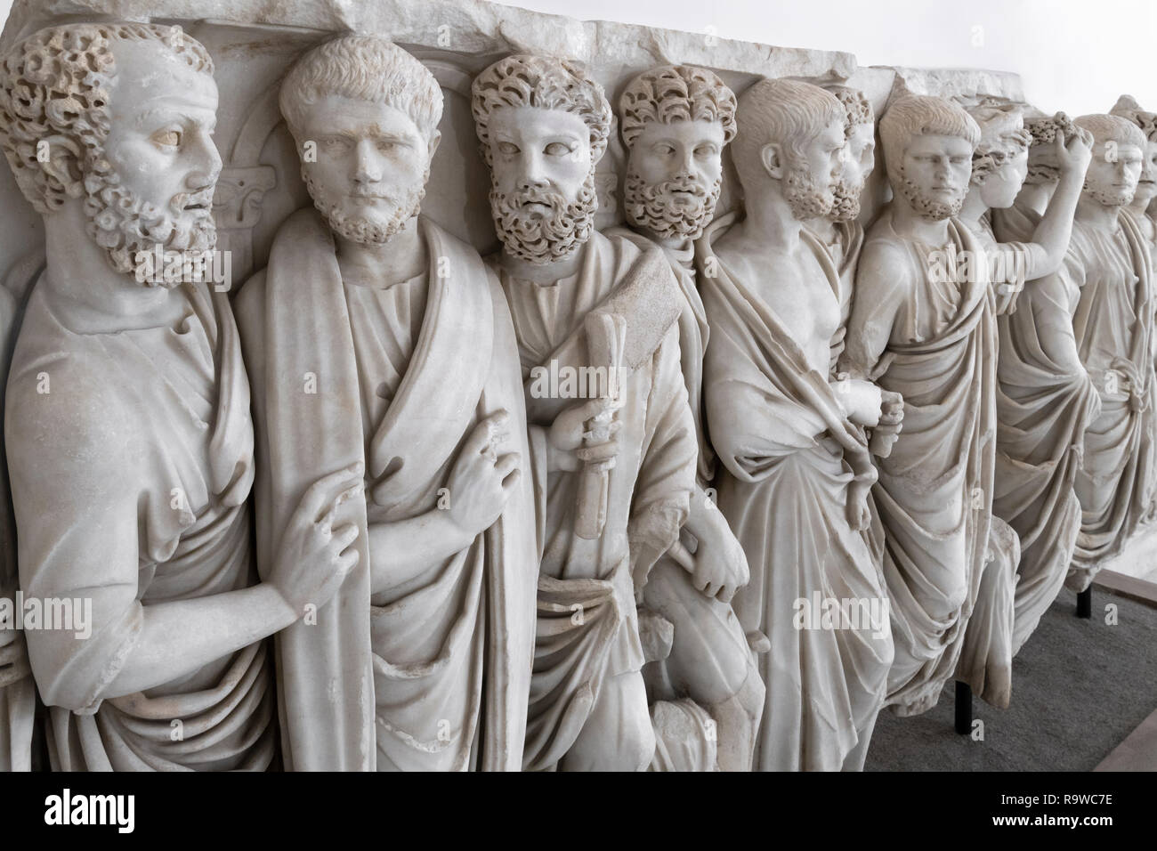 A Roman sarcophagus of the   3rd cen. AD, depicting men in traditional Roman dress, the toga,  In the National Archaeological Museum at Naples, Italy. Stock Photo