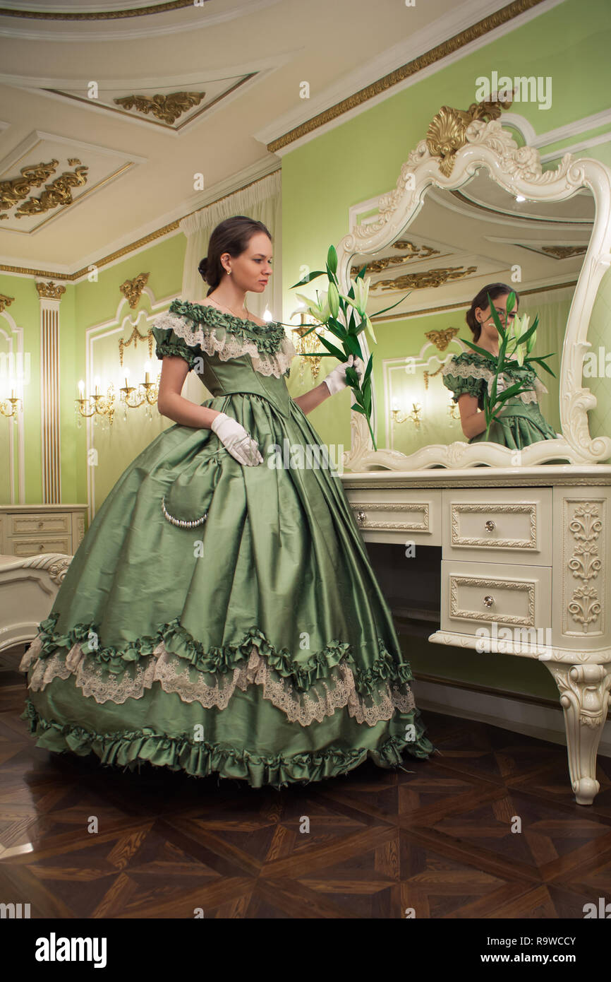 Portrait of retro baroque fashion woman wearing green vintage dress at ...
