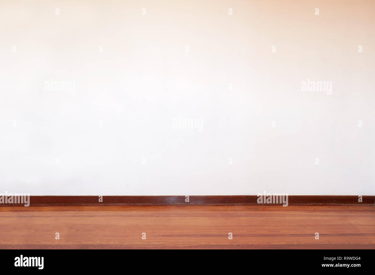 Empty room with wooden floor and blank wall in a country house Stock Photo