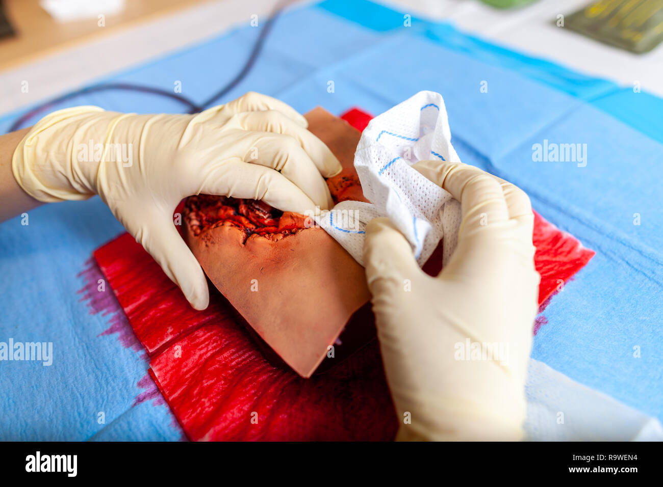 German military medic practice bleeding control on a wound dummy Stock Photo