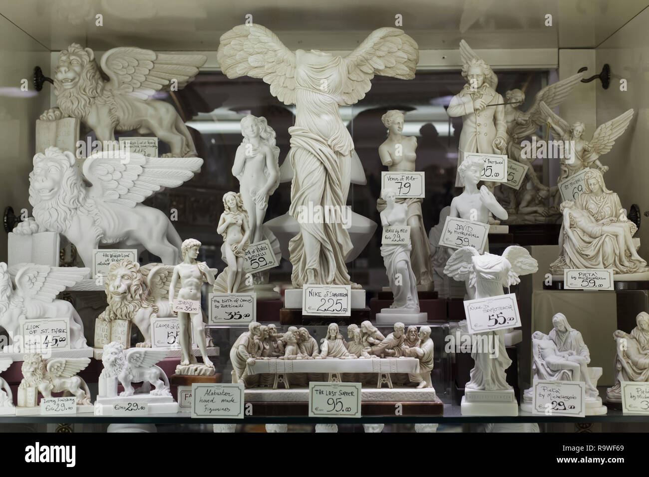 Hand made alabaster statuettes on sale in a souvenir shop in Venice, Italy.  Statuettes of Winged Nike of Samothrace, Aphrodite of Milos, David by  Michelangelo Buonarroti, Venus by Sandro Botticelli, Last Supper