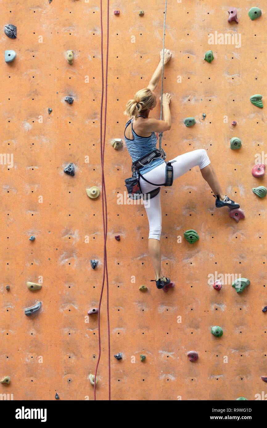 bouldering, girl climbing up the wall Stock Photo Alamy