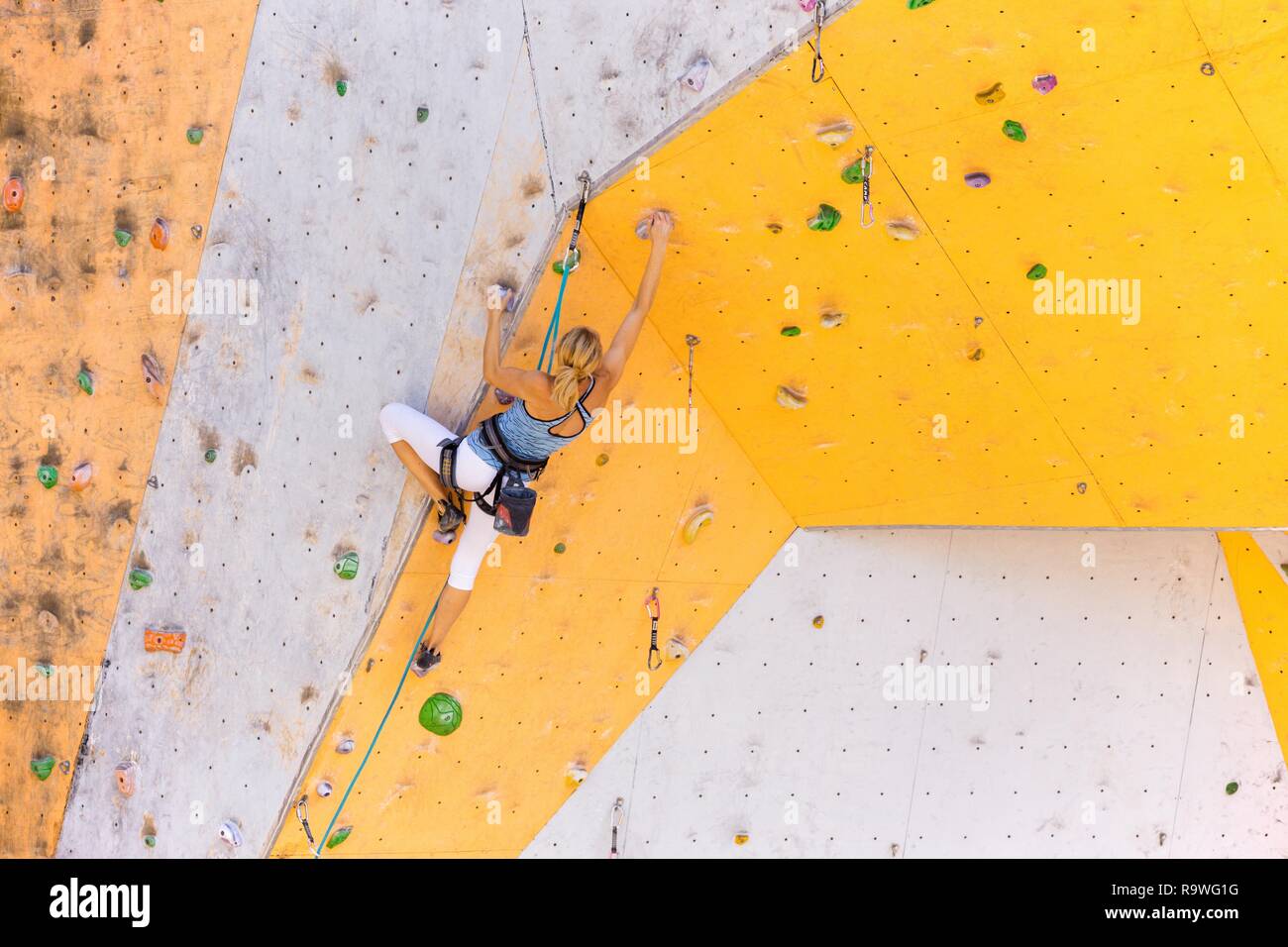 bouldering, girl climbing up the wall Stock Photo Alamy