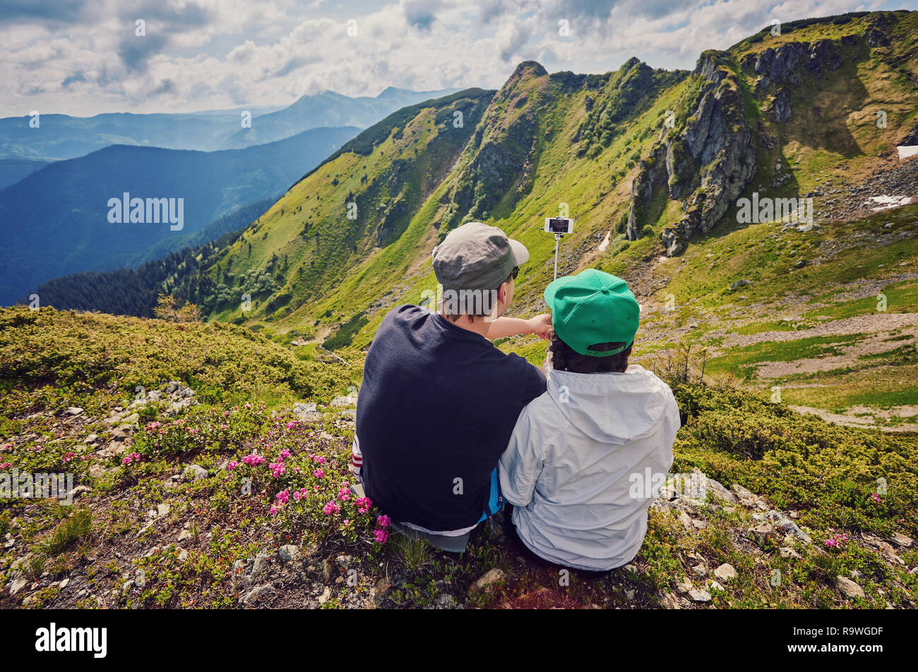 Young couple hiking taking selfie with smart phone. Happy young man and ...