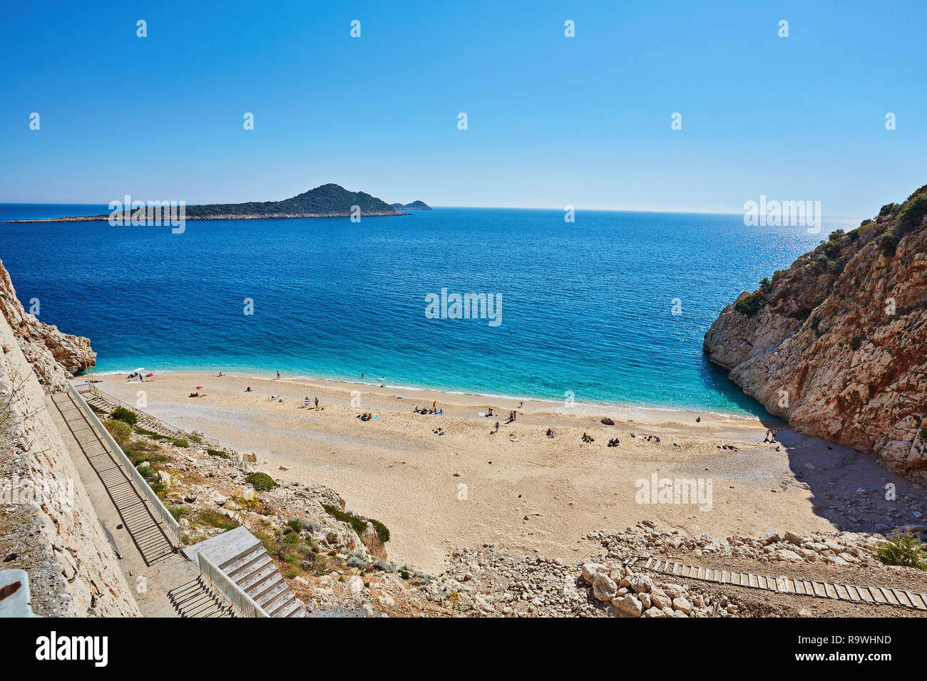 Tourists sunbathing and swimming on the Kaputas Beach, Kas, Antalya Turkey Stock Photo