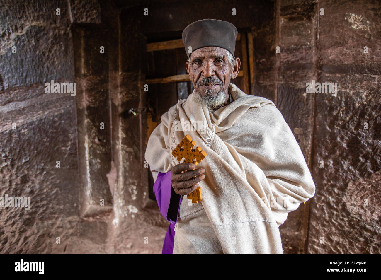 Priest at the rock-cut church of House of Virgins at Lalibela, Ethiopia Stock Photo