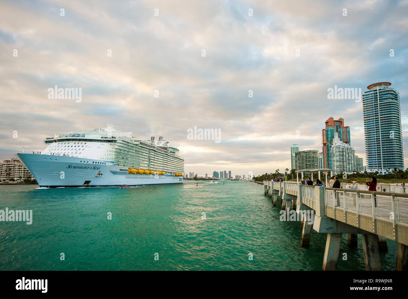 MIAMI - DECEMBER, 2018: The Symphony of the Seas, the largest cruise ship in the world with a capacity of over 6,600 passengers, departs PortMiami. Stock Photo