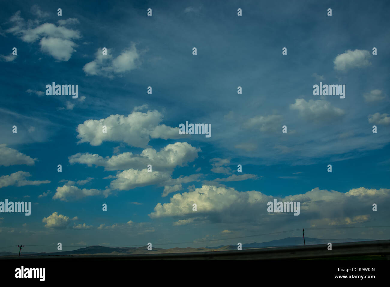 Beautiful view to the blue sky with clouds and some mountain peaks in ...