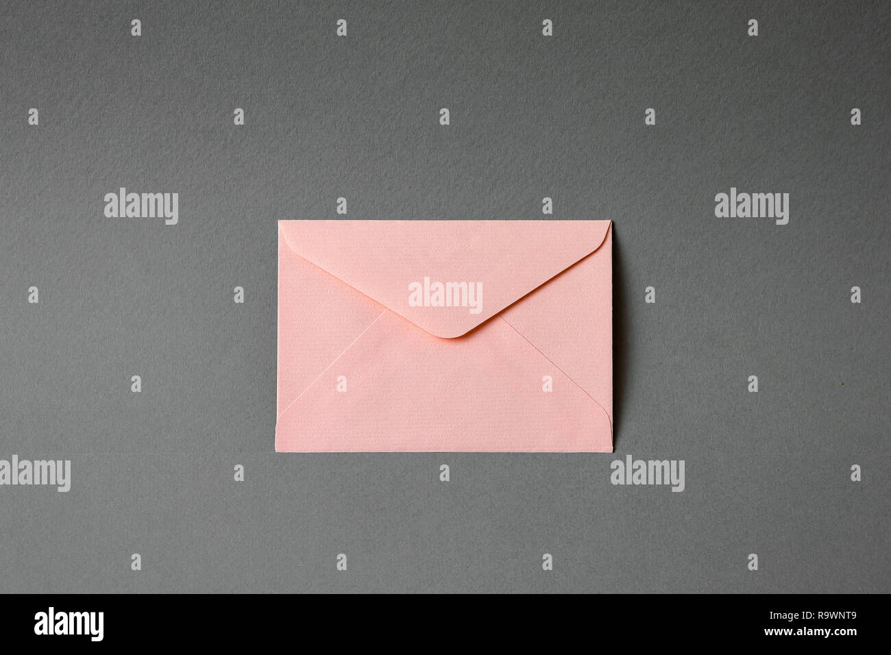 pink envelope with gray background Stock Photo