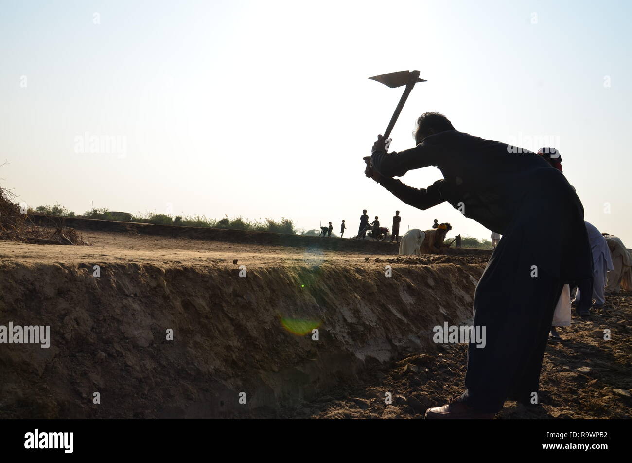 A man plows a canal in rural sindh, pakistan Stock Photo