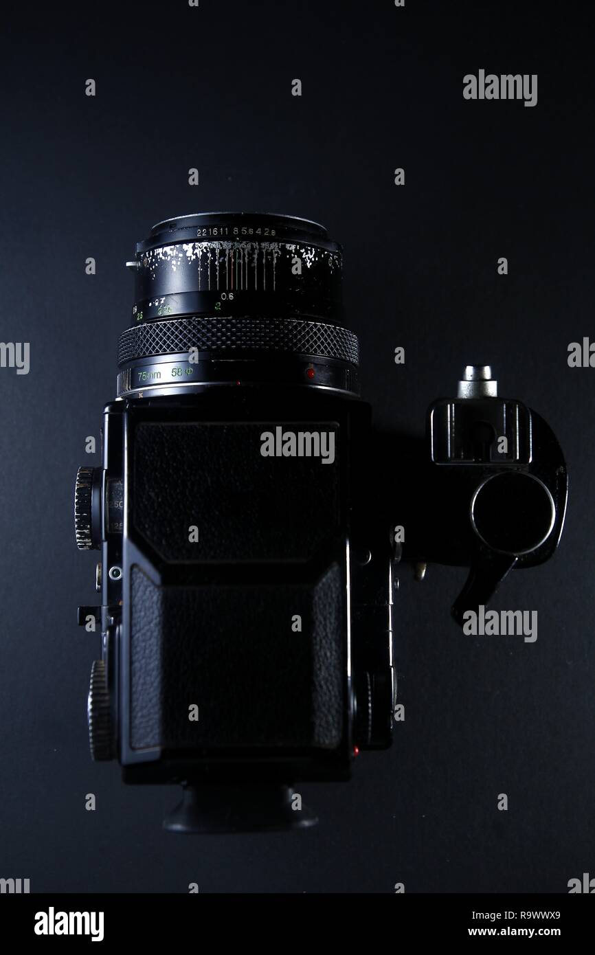 A vintage medium format film camera shot with dramatic lighting and