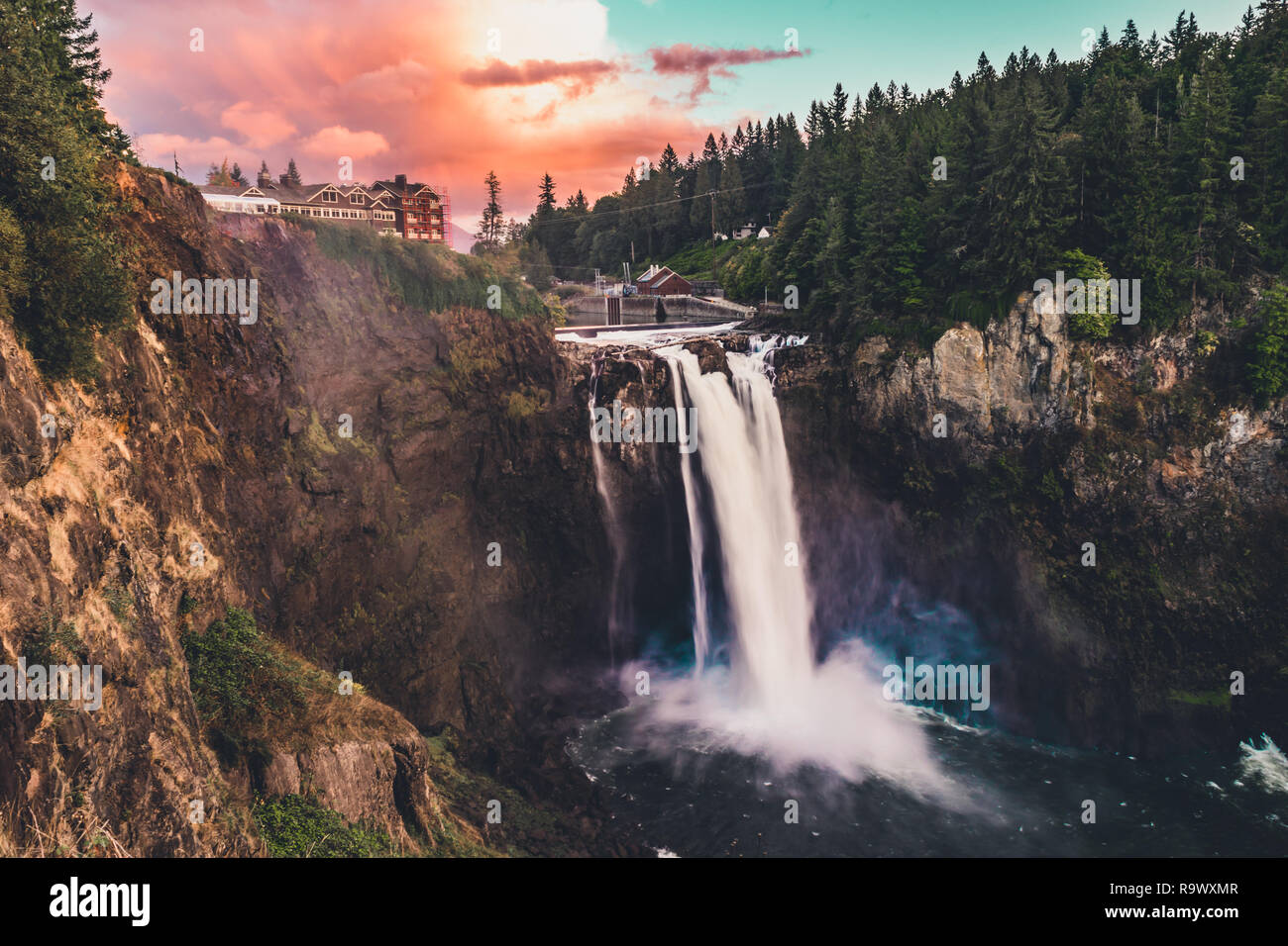 A waterfall known as Snoqualmie Falls flowing at sunset in Snoqualmie Washington Stock Photo