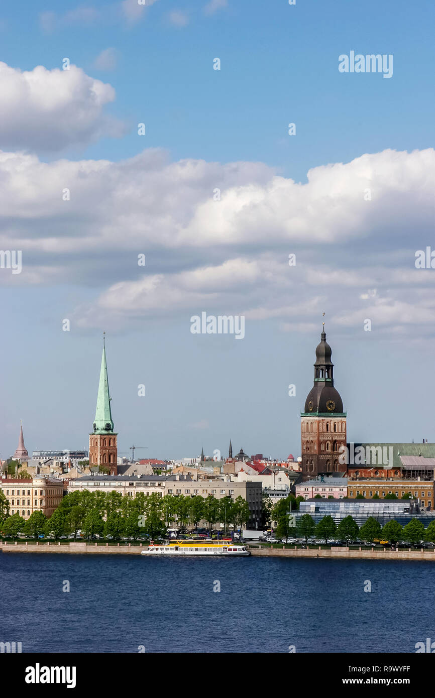 Riga, capital city of Latvia. View of St Peter's Church and St. Jacob's Cathedral. View of Old Riga with Daugava river in the foreground. City Riga wi Stock Photo