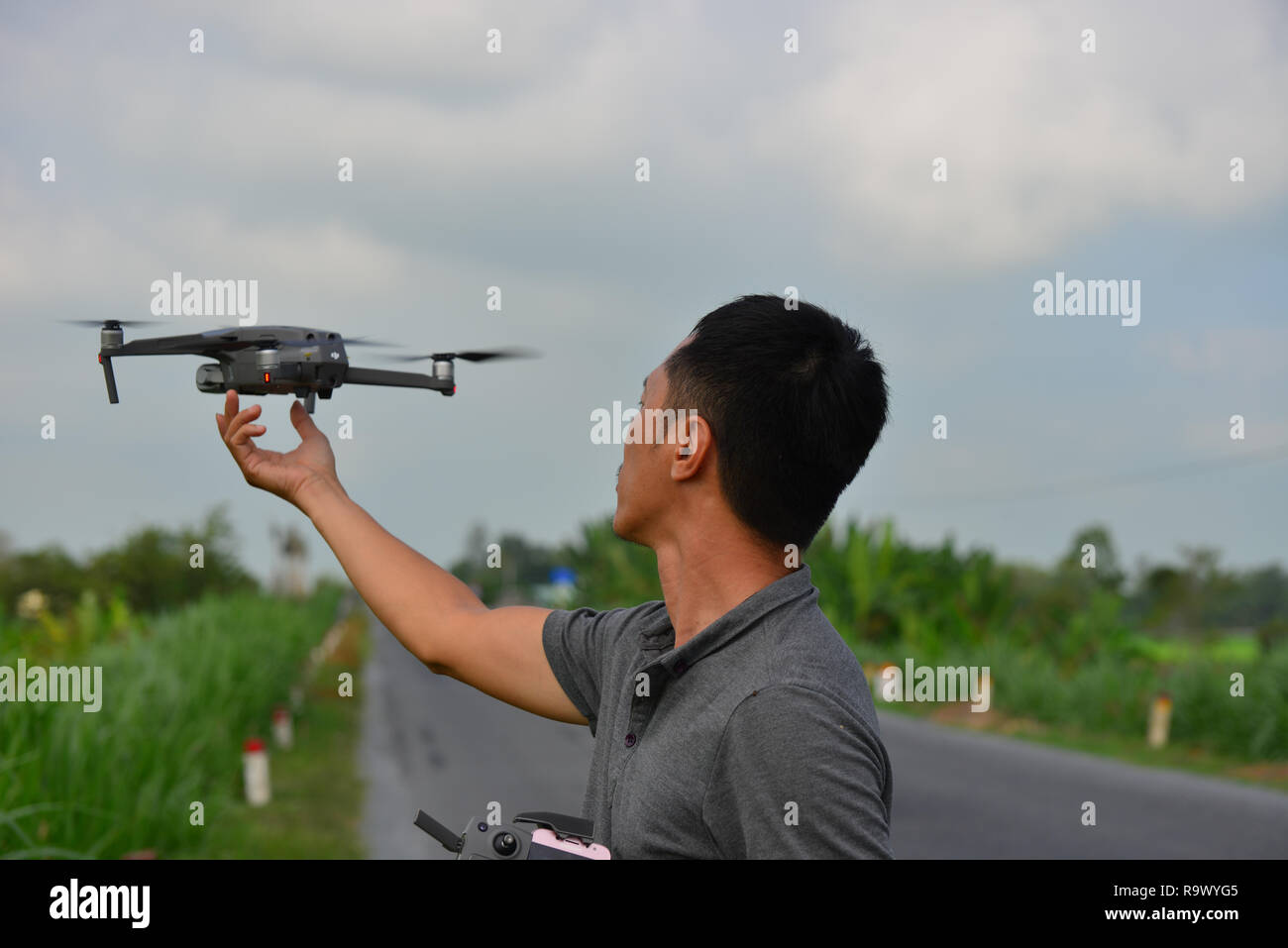 Can Tho, Vietnam - Nov 17, 2018. A young man holding the Mavic 2 Pro drone  at countryside. Drone use is allowed in Vietnam but need a flying license  Stock Photo - Alamy