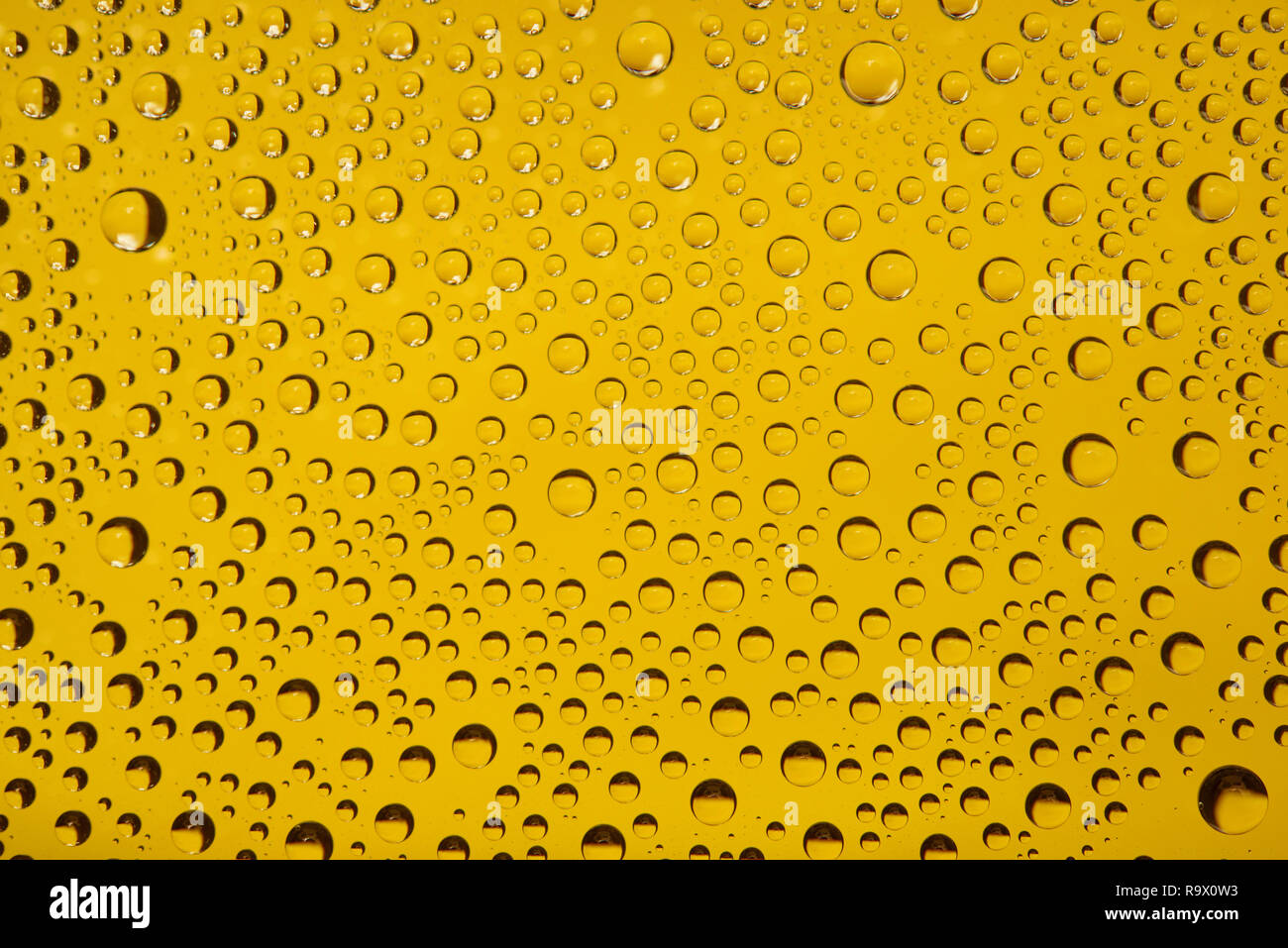 Water drops on a yellow background Stock Photo - Alamy